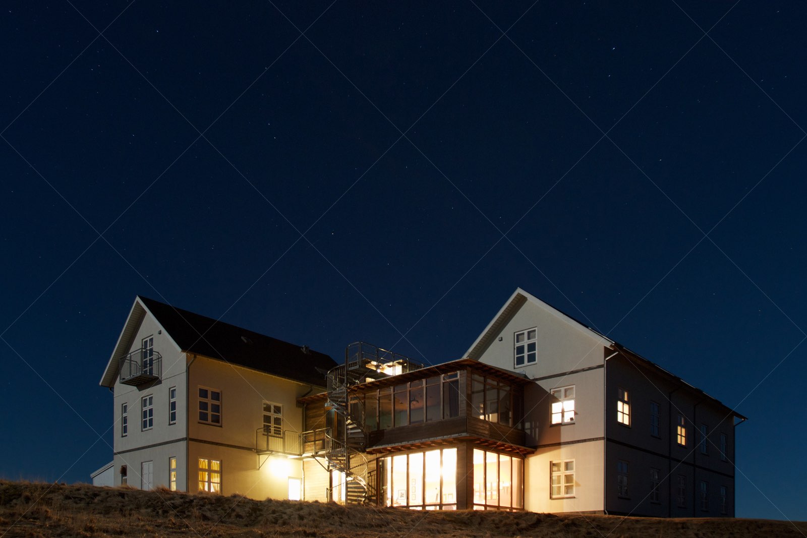 Hotel Búdir illuminated at night in Snæfellsbær Iceland