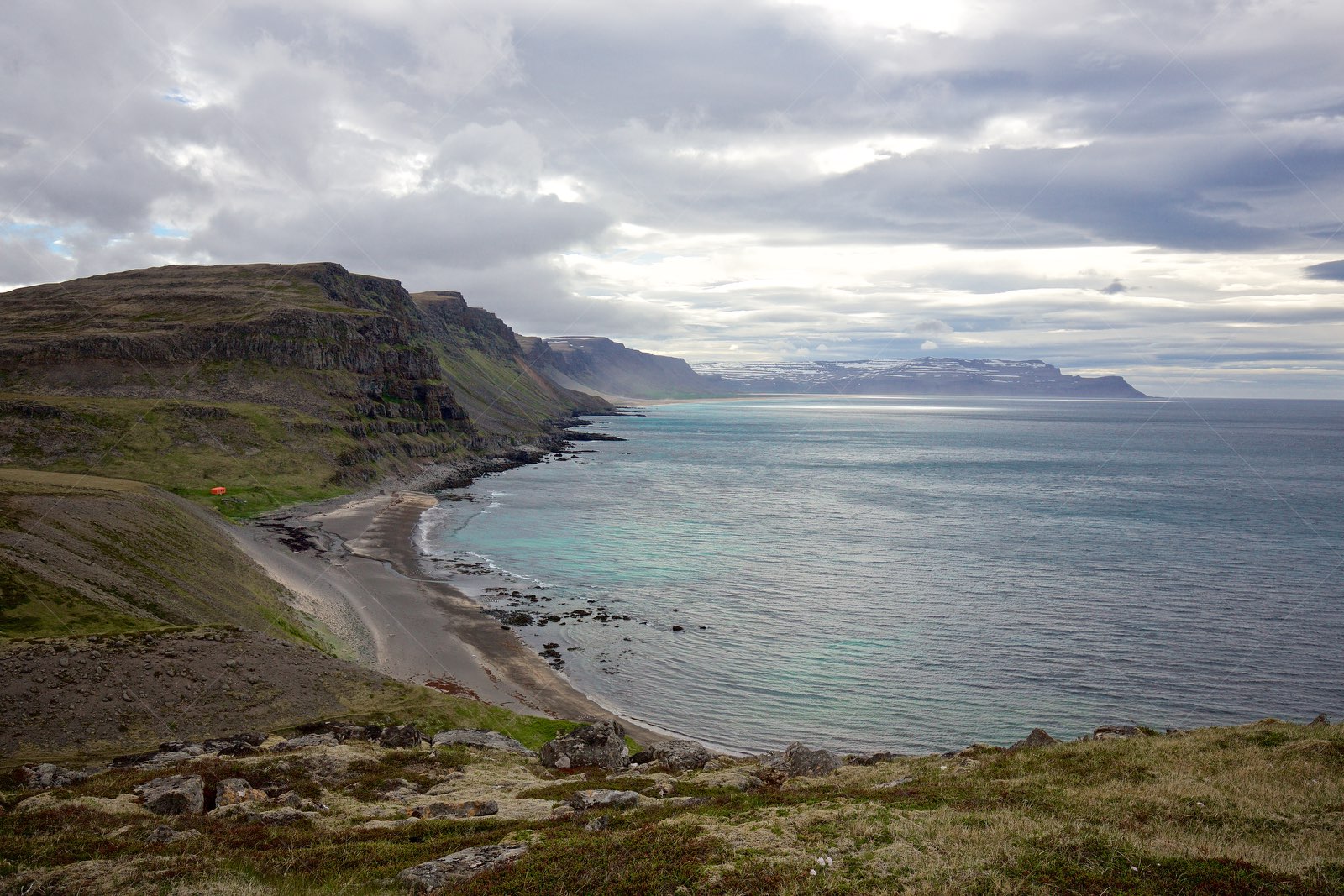Rocky coastline with cliffs and beach in Vesturbyggð Iceland